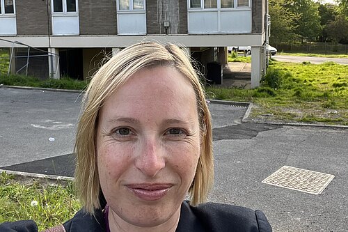 Claire standing outside Croydon council housing