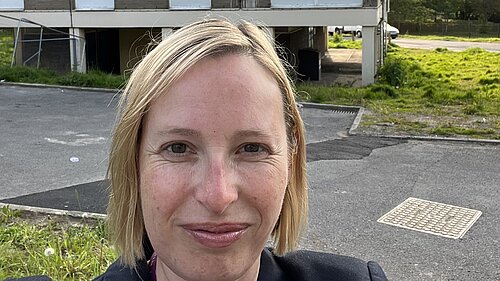 Claire standing outside Croydon council housing